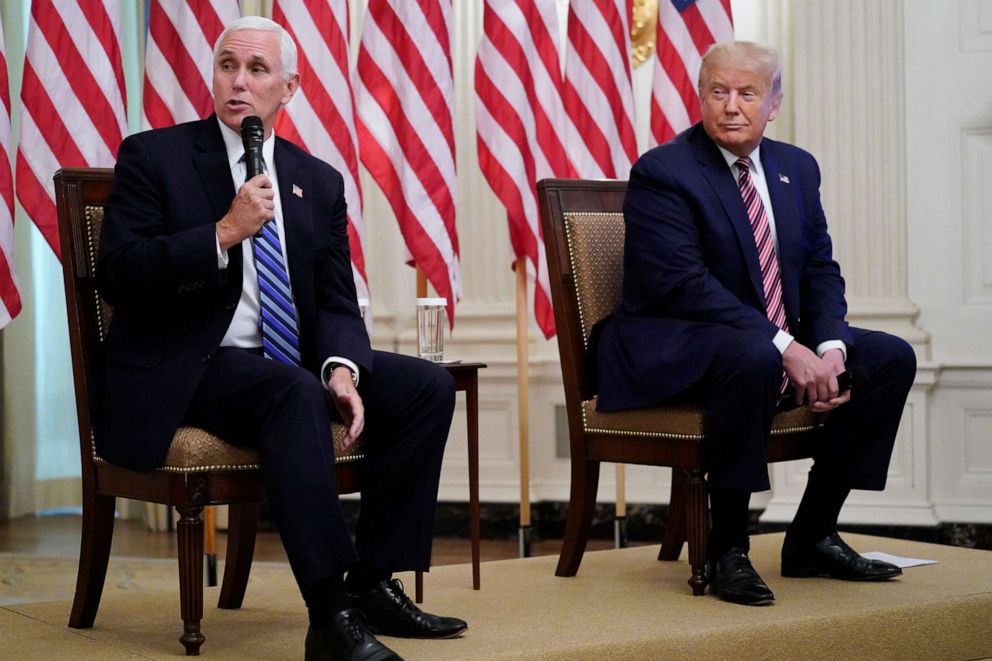 PHOTO: President Donald Trump listens as Vice President Mike Pence speaks at an event called "Kids First: Getting America's Children Safely Back to School" in the State Dining room of the White House, Aug. 12, 2020.