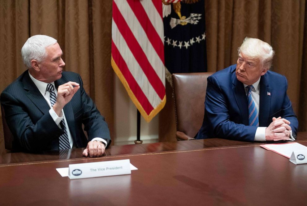 PHOTO: Vice President Mike Pence peaks during a roundtable meeting on seniors in the Cabinet Room at the White House in Washington, DC, June 15, 2020.