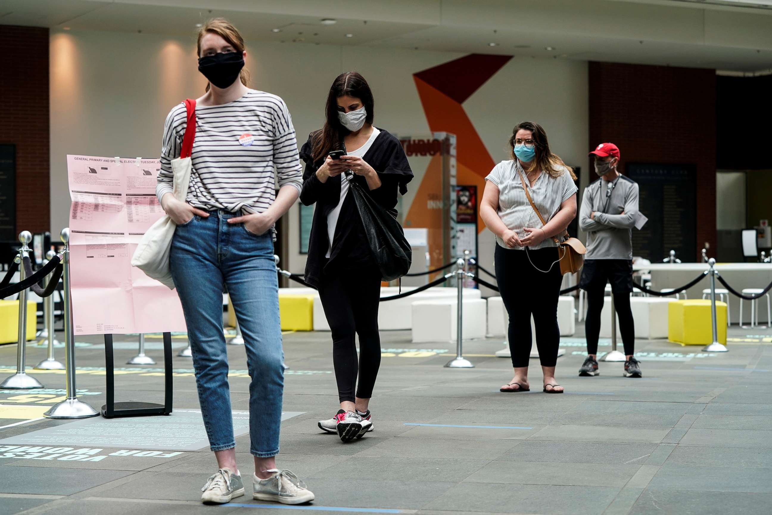 PHOTO: In this June 2, 2020, file photo, people wearing masks to prevent the spread of COVID-19 wait to vote in the primary election in Philadelphia.