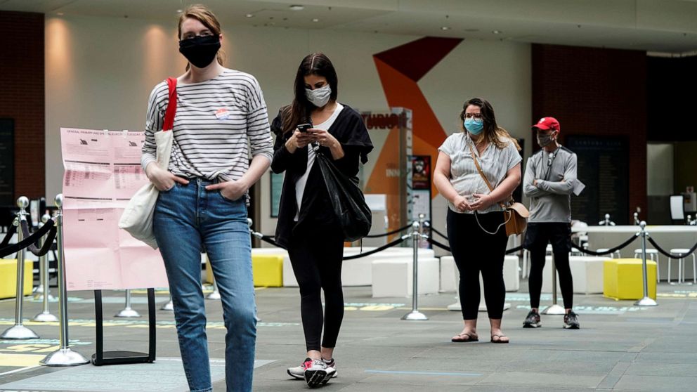PHOTO: In this June 2, 2020, file photo, people wearing masks to prevent the spread of COVID-19 wait to vote in the primary election in Philadelphia.