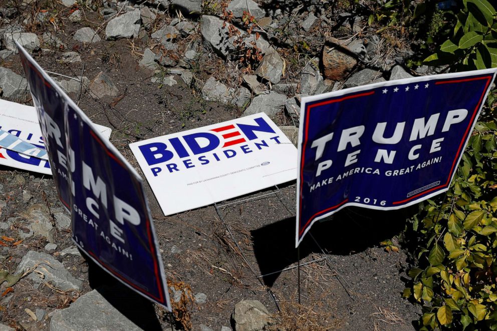 PHOTO: Campaign signs are pictured as supporters of President Donald Trump gather ahead of his campaign stop in Old Forge, Pa., Aug. 20, 2020. 