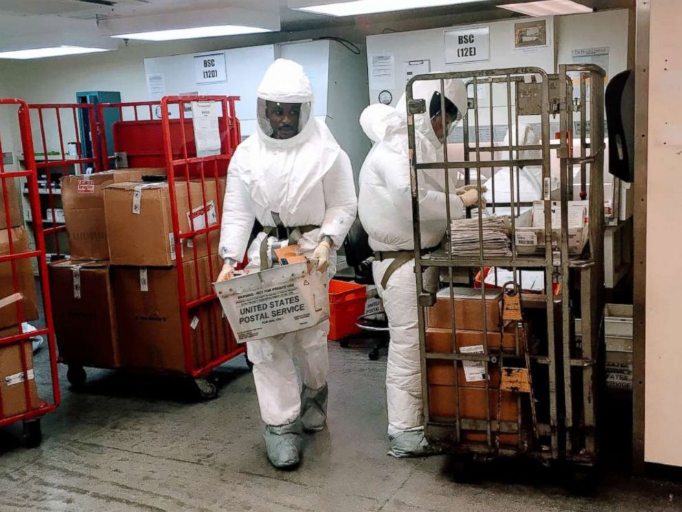 PHOTO: US Defense Department personnel, wearing protective suits, screen mail as it arrives at the Pentagon in Washington, Oct. 2, 2018.