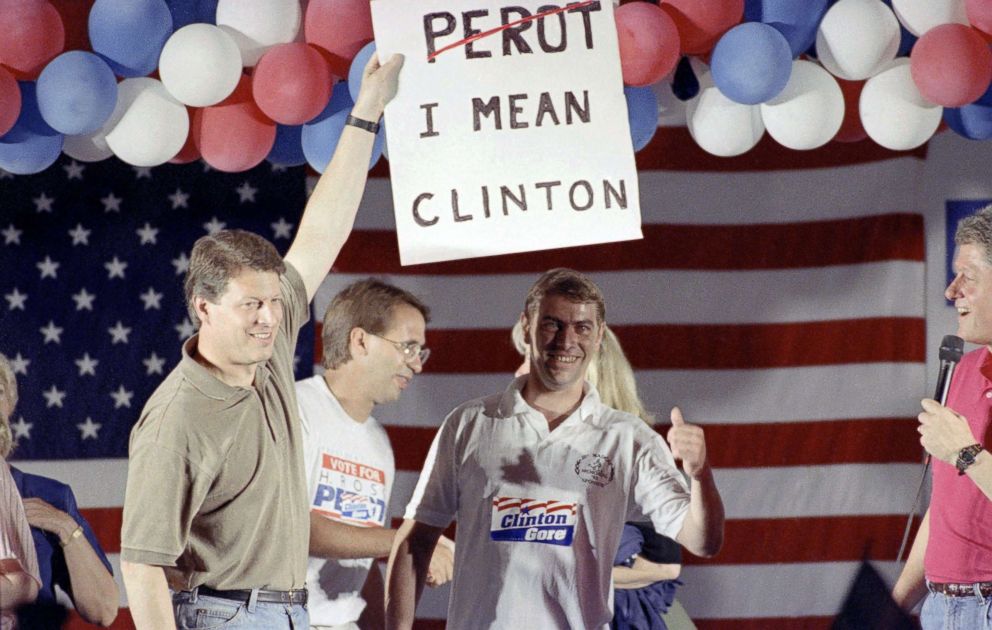 PHOTO: Democratic vice-presidential candidate Al Gore holds a former Perot supporter's sign at a rally gathered in Utica, Ohio, July 20, 1992 as Bill Clinton watches at far right.