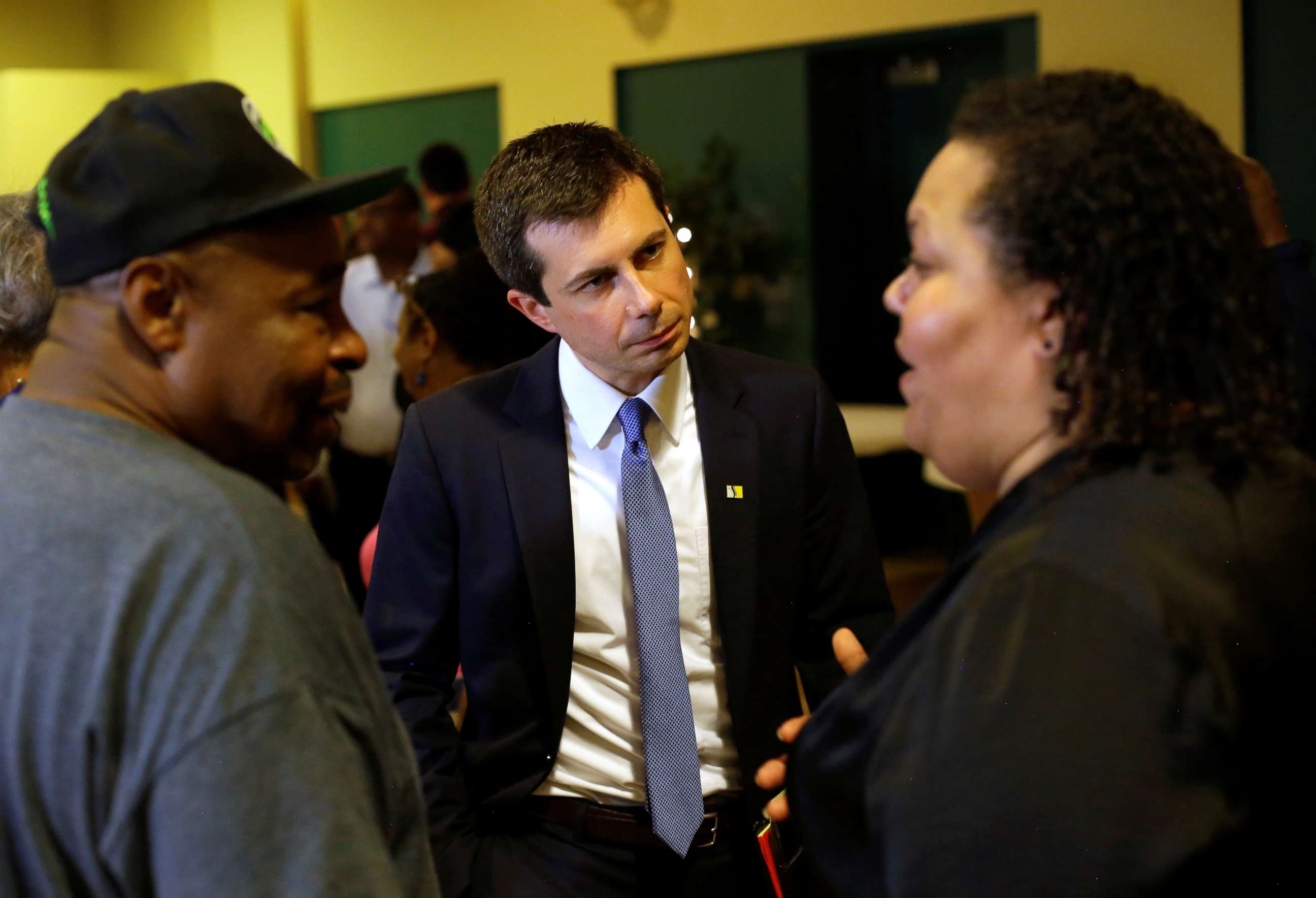PHOTO: South Bend Mayor and 2020 presidential candidate Pete Buttigieg talks with Samuel Brown and his daughter Jasmine Brown after meeting with community leaders to discuss policing policies in the community in South Bend, Ind., July 1, 2019.