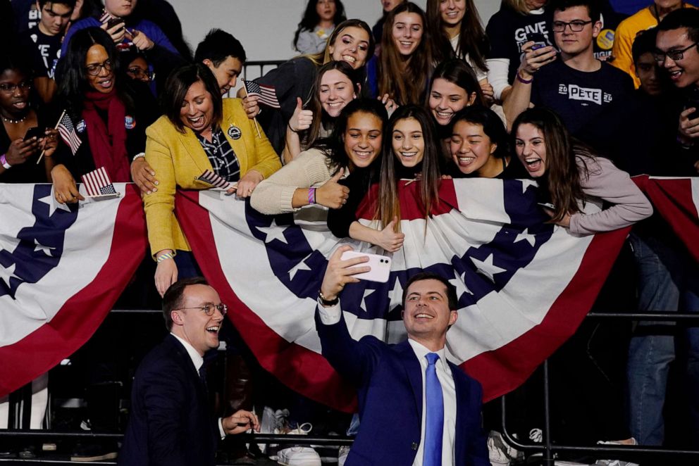 PHOTO: Democratic presidential candidate Pete Buttigieg pose for a selfie with supporters at an election night rally in Des Moines, Iowa, Feb. 3, 2020.