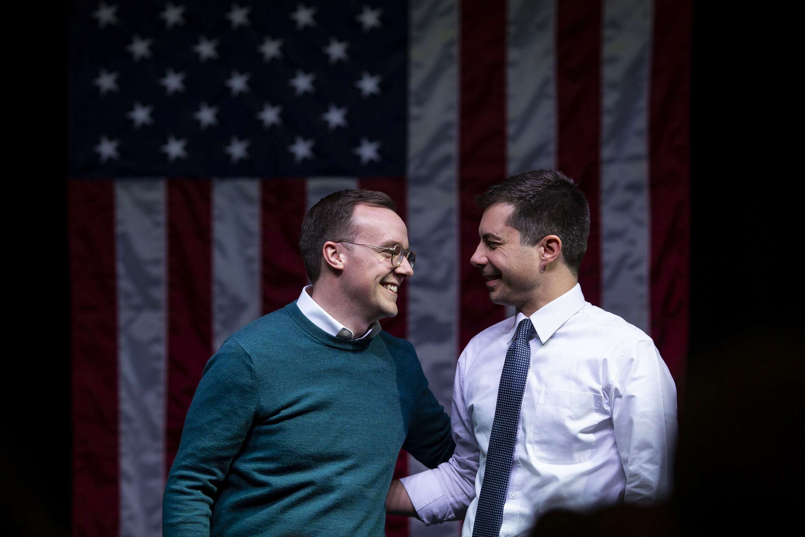 PHOTO: Pete Buttigieg and husband Chasten Buttigieg, left, stand on stage during a campaign event in Indianola, Iowa, on Jan. 28, 2020.