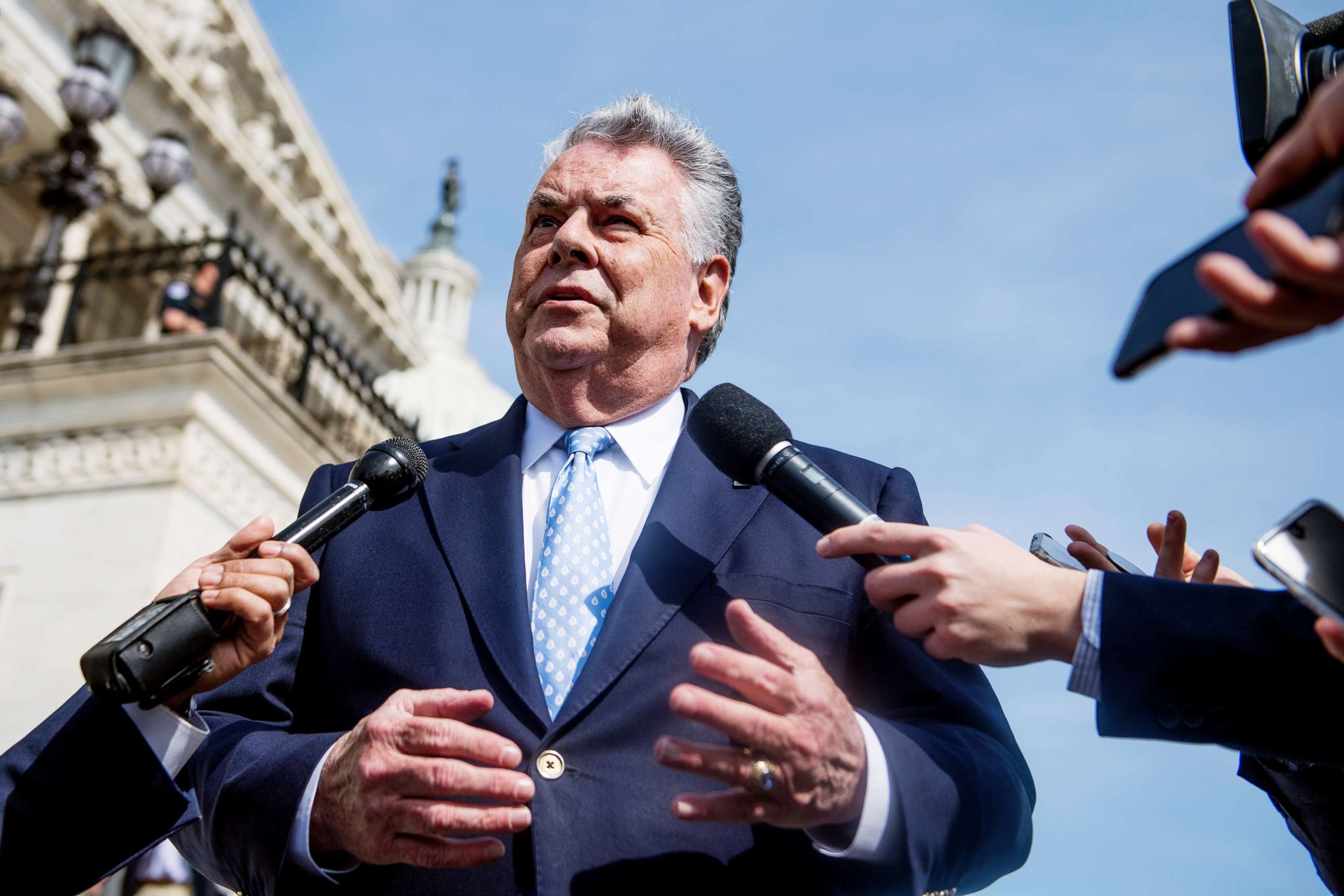 PHOTO: Rep. Peter King talks with reporters at the base of the House steps after the last votes of the week on April 13, 2018.