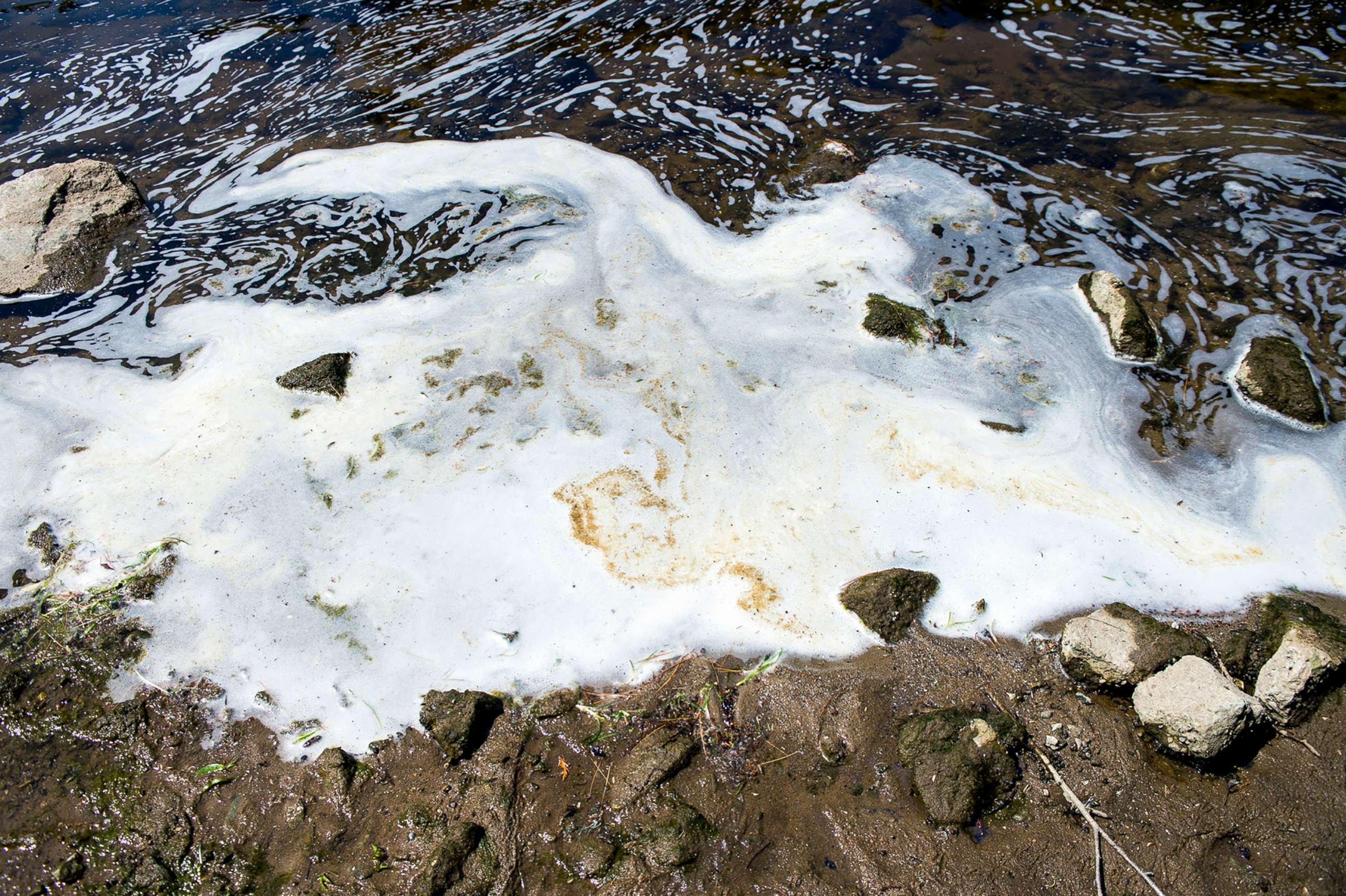 PHOTO: PFAS foam gathers at the the Van Etten Creek dam near Wurtsmith Air Force Base in Michigan, June 7, 2018.