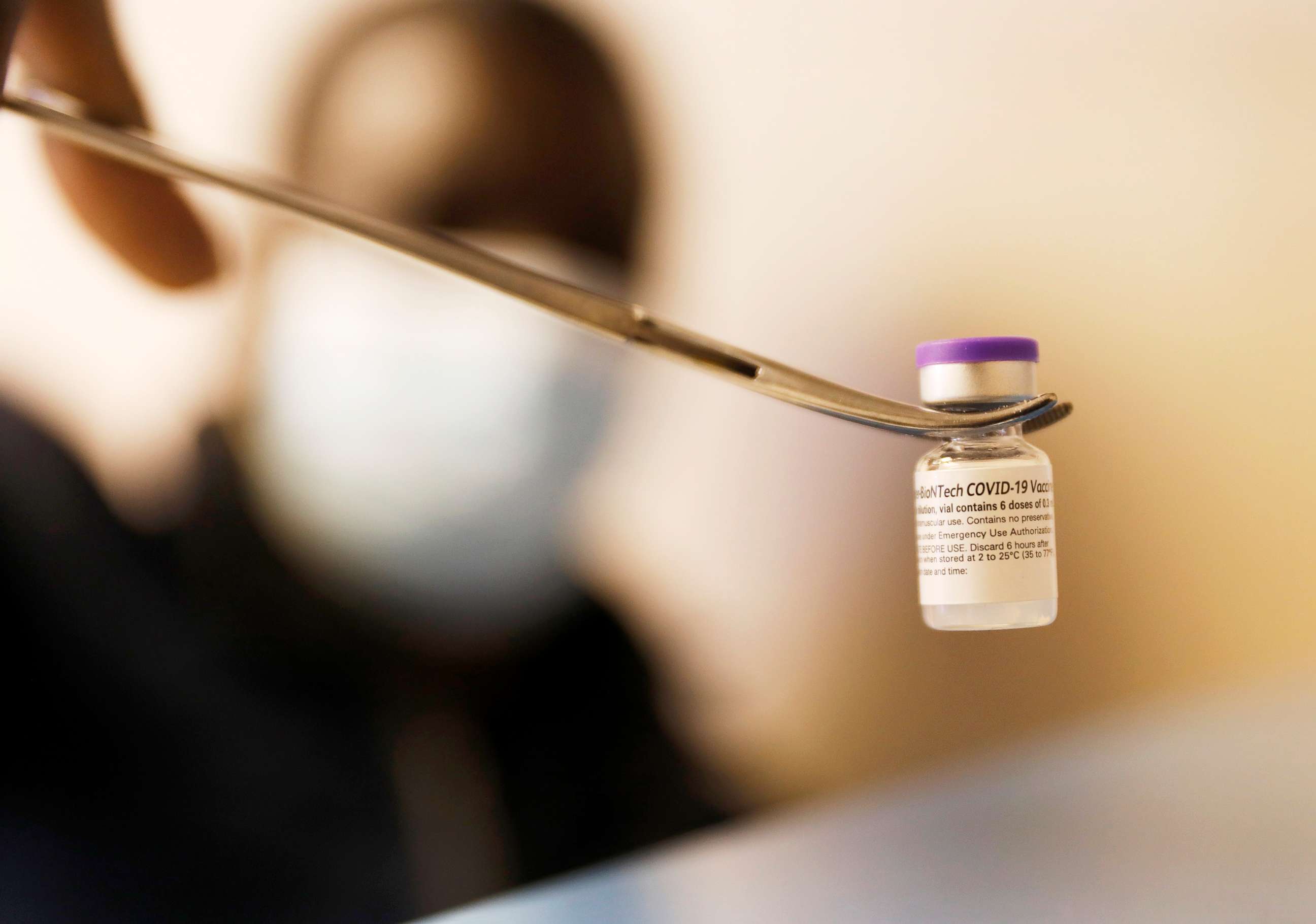 PHOTO: A vial containing roughly 6 doses of the Pfizer COVID-19 vaccine is displayed in Vernon, Calif., March 23, 2021.