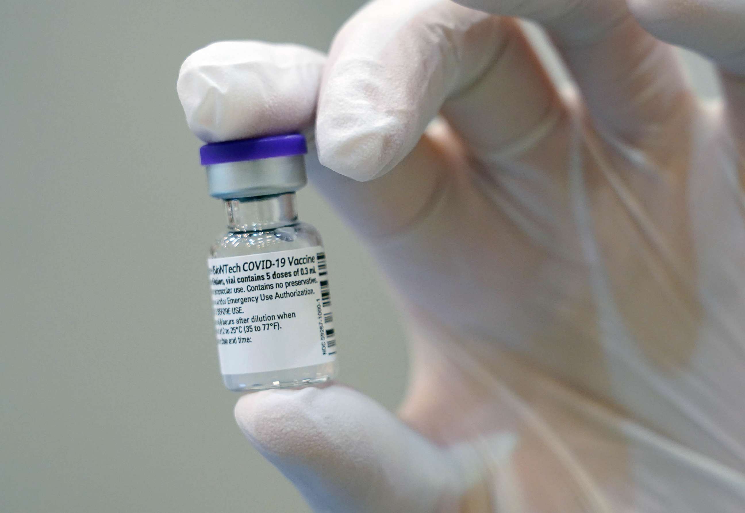 PHOTO: A doctor holds up a bottle of the Pfizer/BioNTech vaccine against Covid-19 at the vaccination center on Jan. 5, 2021 in Potsdam, Germany.