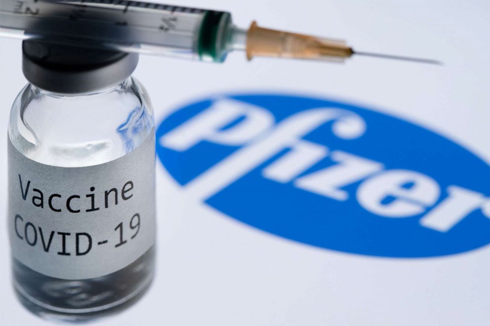 PHOTO: A syringe and a bottle reading "Covid-19 Vaccine" next to the Pfizer company logo, Nov. 23, 2020.