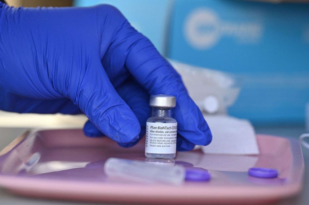 PHOTO: A nurse reaches for a vial of Pfizer-BioNTech Covid-19 vaccine at a pop up vaccine clinic in the Arleta neighborhood of Los Angeles, Aug. 23, 2021.
