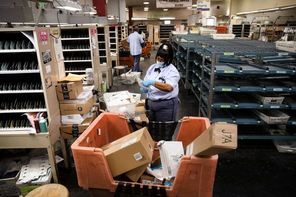 PHOTO: United States Postal Service carrier Henrietta Dixon sorts mail to be delivered before she sets out on her route in Philadelphia, May 6, 2020.