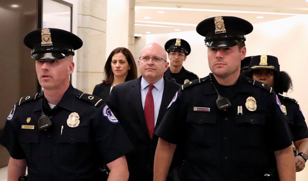 PHOTO: Philip Reeker, acting assistant secretary of state for European and Eurasian Affairs, is escorted by police officers as he leaves after testifying in impeachment inquiry against President Donald Trump, in Washington D.C., Oct. 26, 2019.
