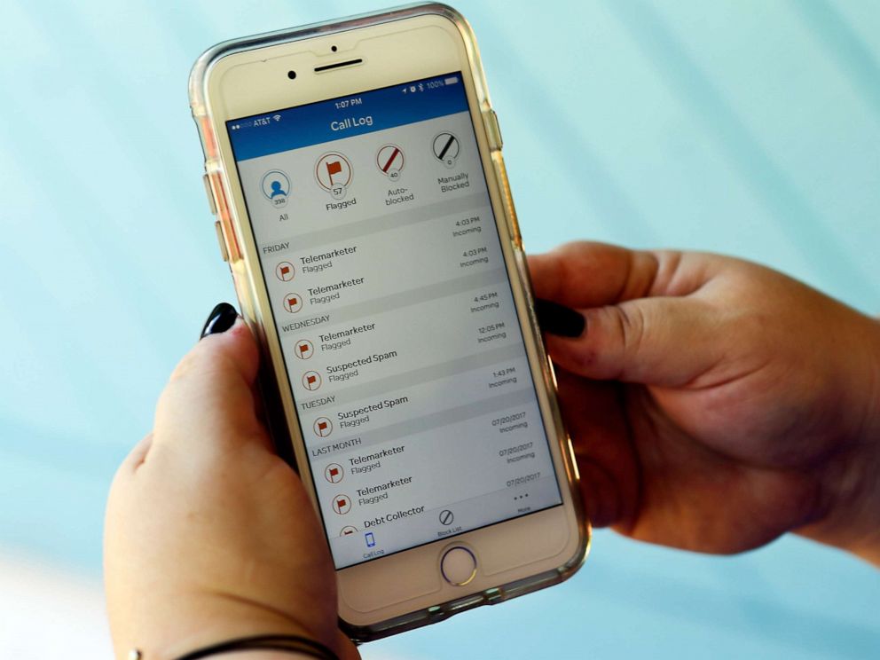 PHOTO: A cellular phone customer looks at a call log displayed via an AT&T app on her cellphone at her home in Orlando, Fla., Aug. 1, 2017.