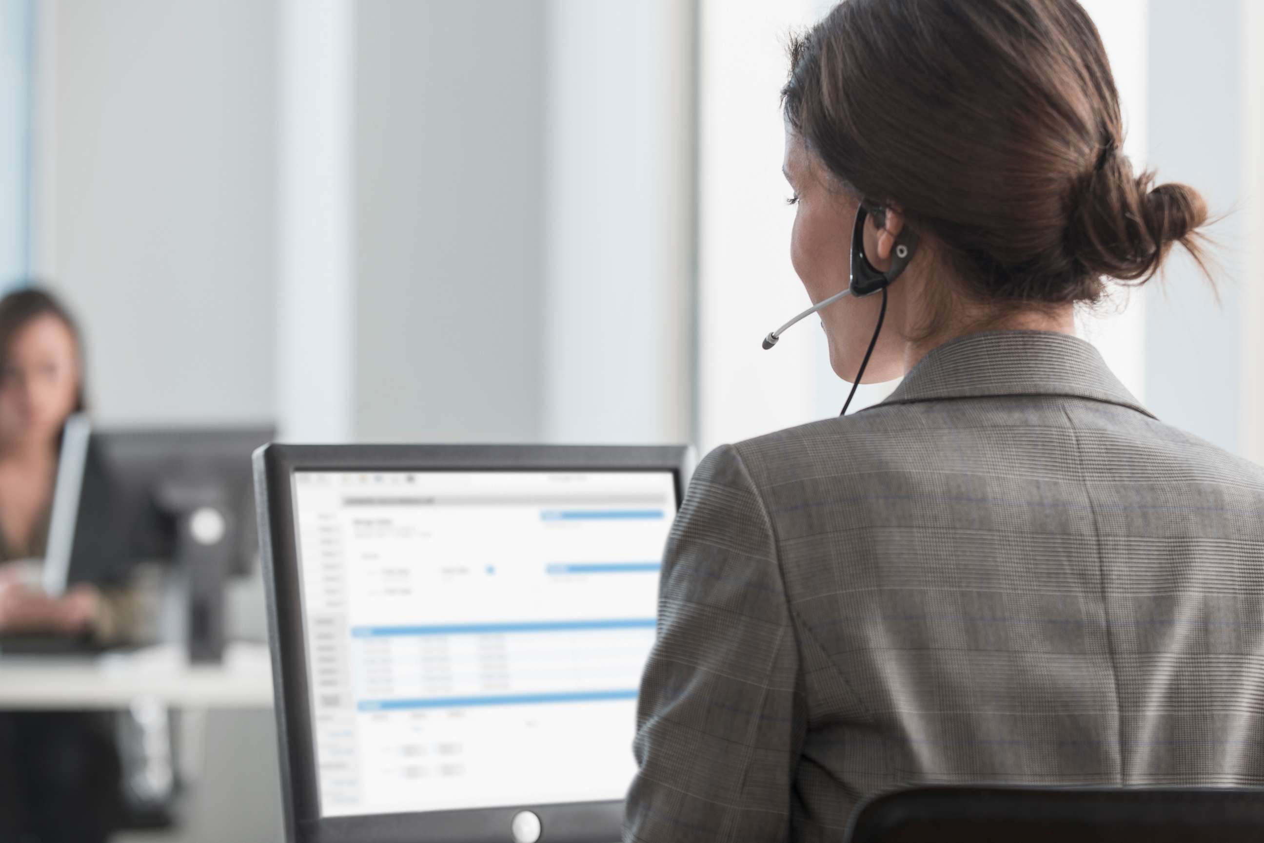 PHOTO: A woman uses a phone headset.