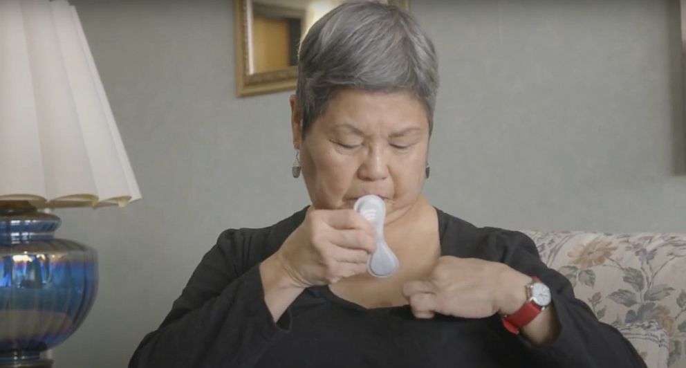 PHOTO: A woman applies a sensor to her chest in an image provided by the Chicago-based company physIQ. 