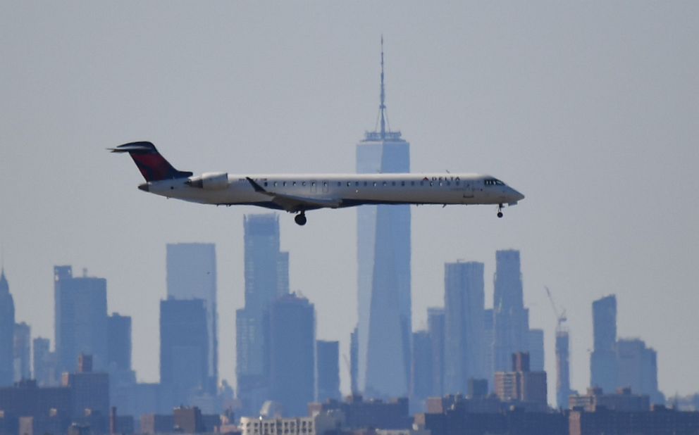 PHOTO: A plane from Delta airline is seen above the skyline of Manhattan before it lands at JFK airport in New York, March 15, 2020.