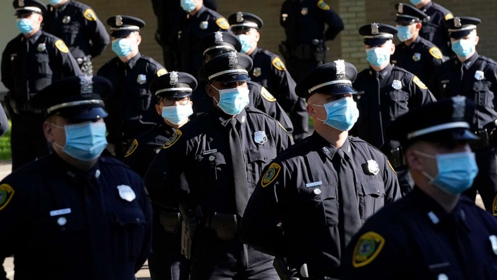 PHOTO: Houston Police cadets wear masks as they prepare to have their class photo taken during a graduation ceremony at the Houston Police Academy, amid the COVID-19 pandemic, Friday, May 1, 2020, in Houston.