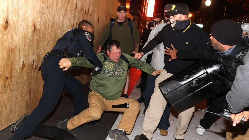 PHOTO: A police officer tries to break up a fight between Black Lives Matter protesters and members of the Proud Boys during a protest following the "Million MAGA March" from Freedom Plaza to the Supreme Court, on Nov. 14, 2020, in Washington, D.C.