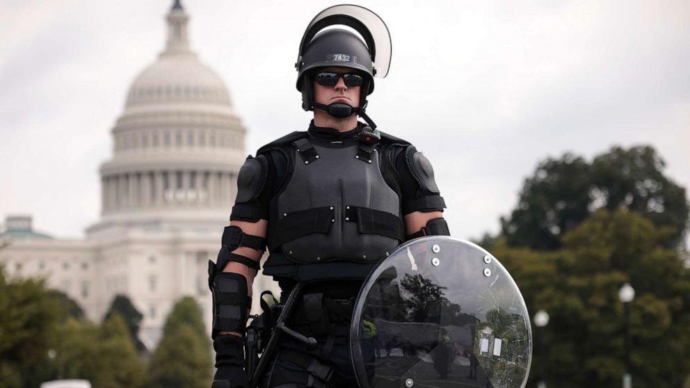 PHOTO: A police officer in riot gear monitors the scene as supporters of those charged in the January 6 attack on the U.S. Capitol attend the 'Justice for J6' rally near the U.S. Capitol on Sept. 18, 2021 in Washington, DC.