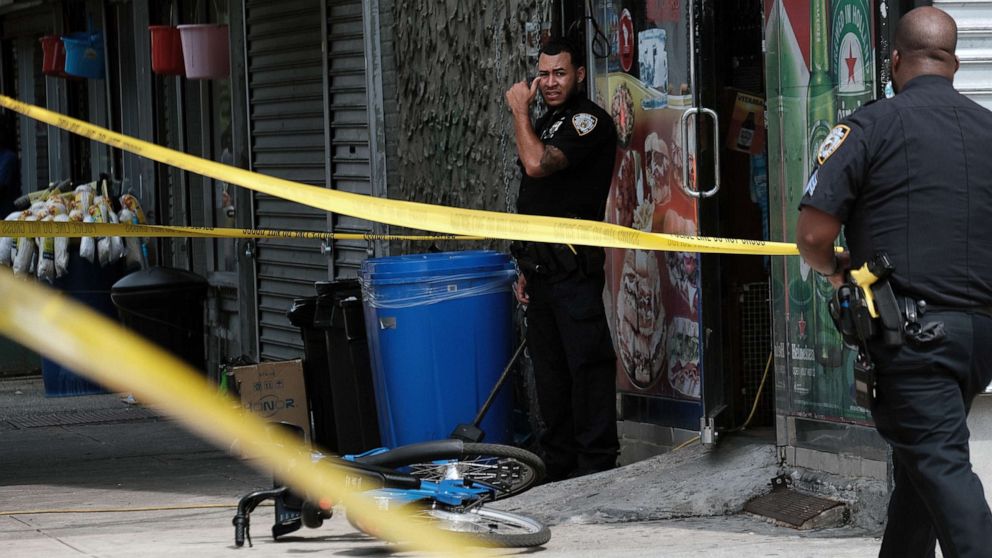 PHOTO: Police converge on the scene of a shooting in Brooklyn, one of numerous during the day, on July 14, 2021, in New York.