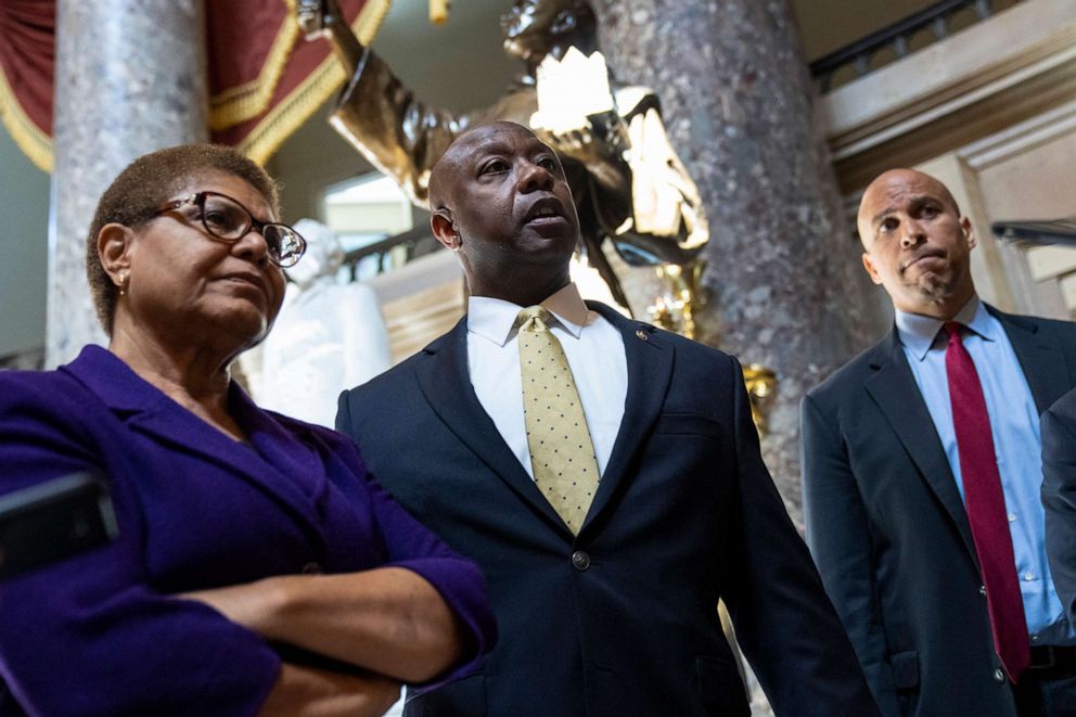 PHOTO: Rep. Karen Bass, Sen. Tim Scott, and Sen. Cory Booker speak briefly to reporters as they exit the office of Rep. James Clyburn following a meeting about police reform legislation on Capitol Hill, May 18, 2021.