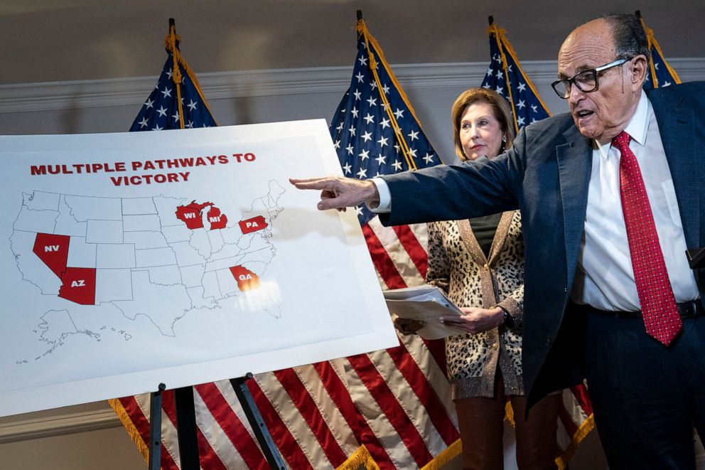 PHOTO: Rudy Giuliani points to a map as he and Sidney Powell speak to the press about various lawsuits related to the 2020 election,  inside the Republican National Committee headquarters in Washington, Nov. 19, 2020.