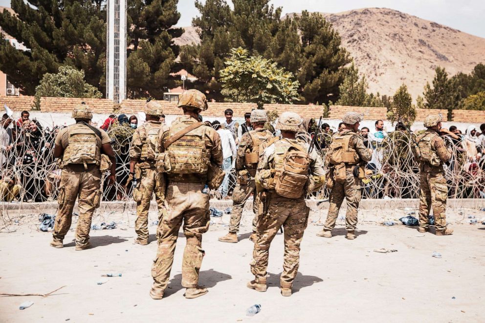 PHOTO: U.S. Soldiers and Marines assist with security at an Evacuation Control Checkpoint during an evacuation at Hamid Karzai International Airport, Kabul, Afghanistan, Aug.  19, 2021.