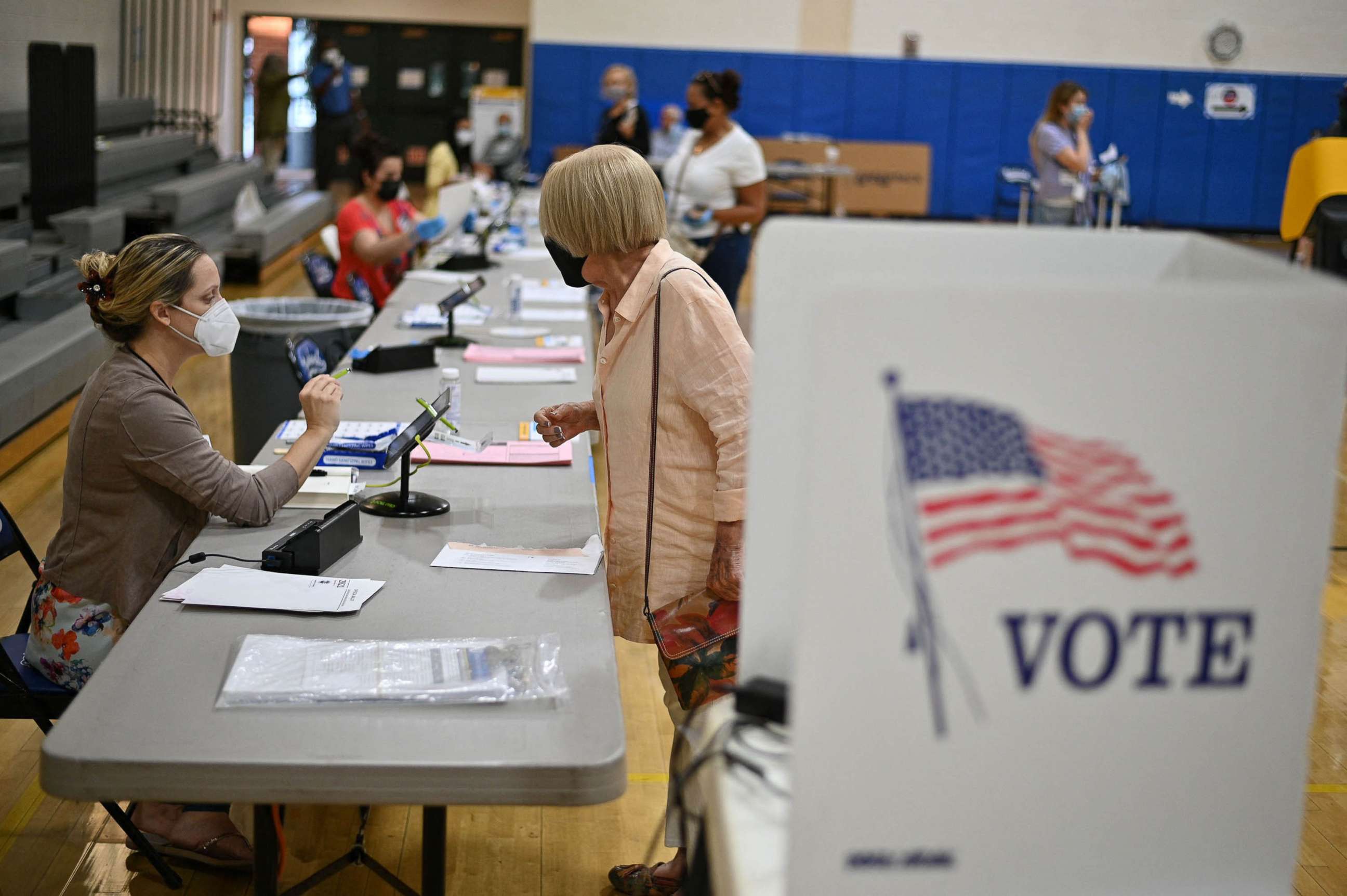 PHOTO: Poll workers assist voters in  in Burbank, Calif., Sept. 14, 2021.