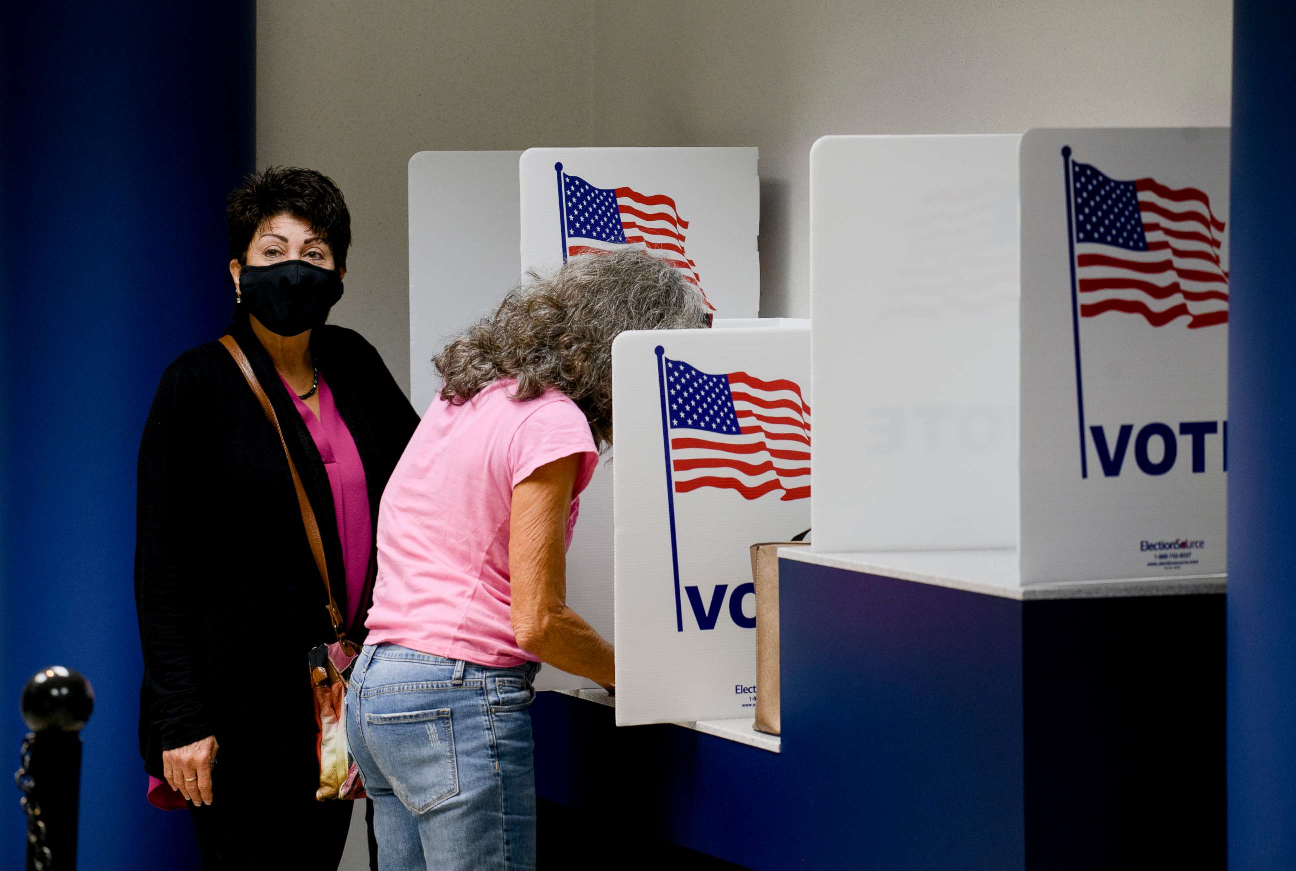 PHOTO: From left, Jackie Binroth waits as her sister Mary Latiff fills out her ballot during early voting in St. Clair Shores, Mich., on Sept. 24, 2020.