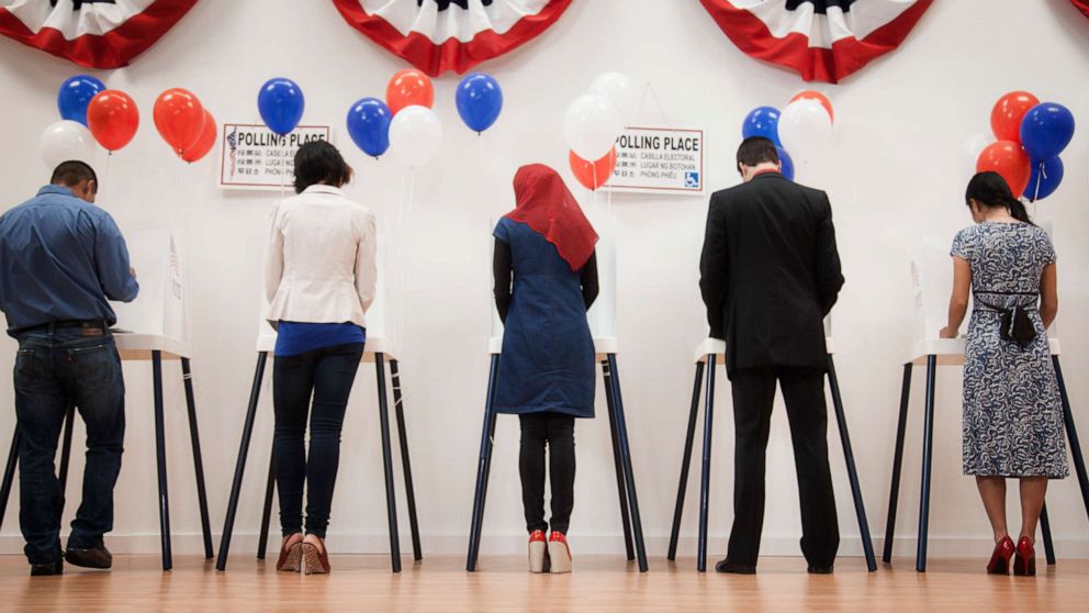 An undated stock photo depicts people casting votes in an election.