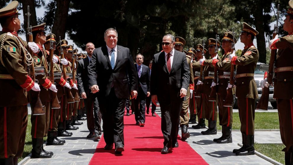 PHOTO: Secretary of State Mike Pompeo walks with Afghan President Ashraf Ghani's Chief of Staff Abdul Salam Rahimi, as he arrives at the Presidential Palace in Kabul, Afghanistan, June 25, 2019.