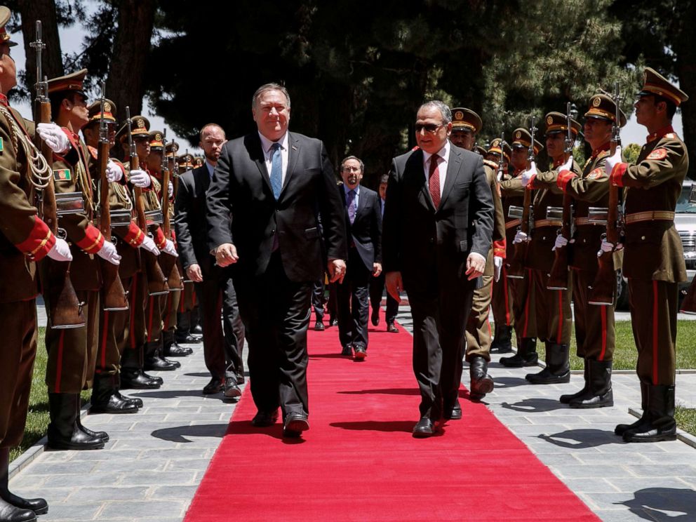 PHOTO: Secretary of State Mike Pompeo walks with Afghan President Ashraf Ghanis Chief of Staff Abdul Salam Rahimi, as he arrives at the Presidential Palace in Kabul, Afghanistan, June 25, 2019.