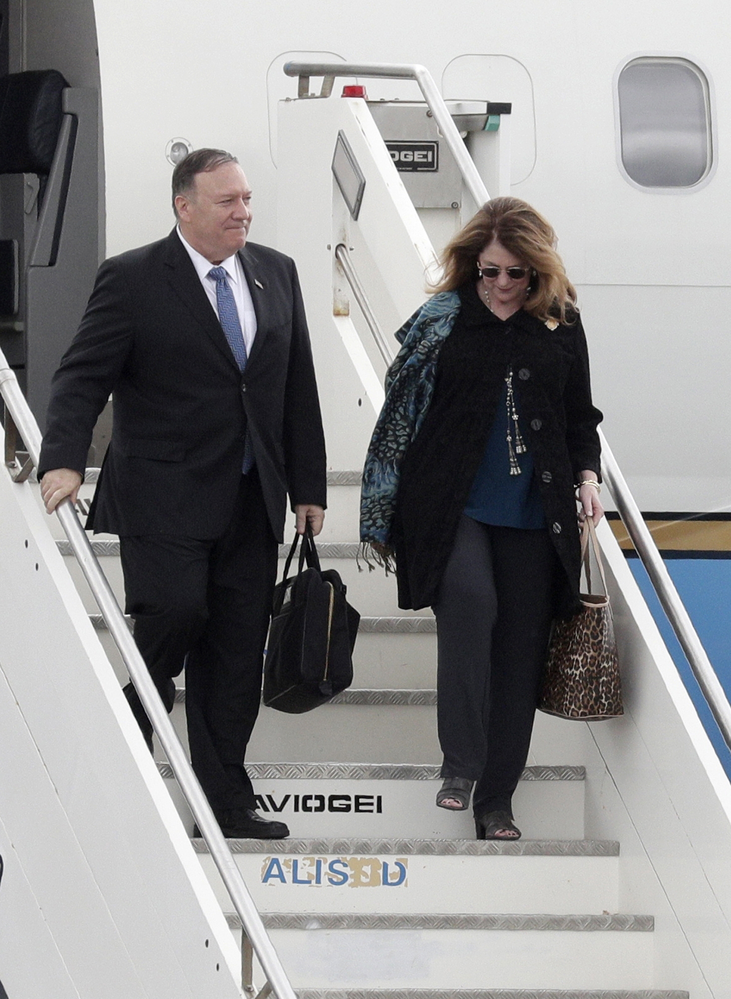 PHOTO: Secretary of State Mike Pompeo and his wife Susan Pompeo walk out of the plane upon arriving at Ciampino military airport, in Rome, Oct. 1, 2019.