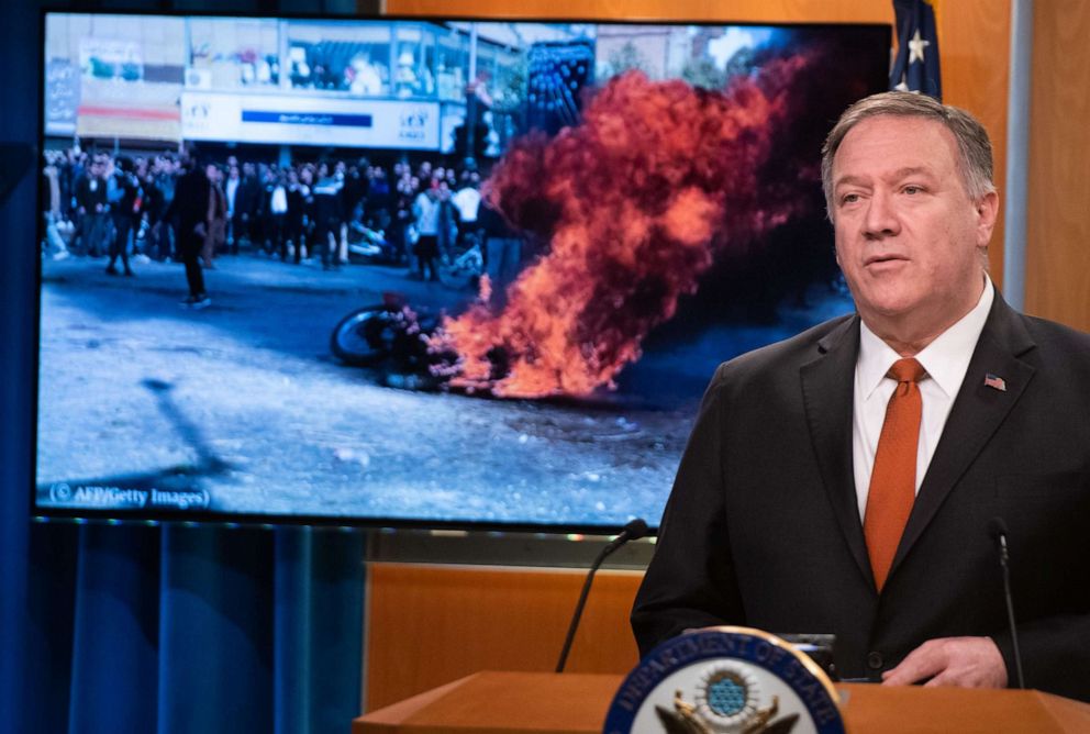PHOTO: U.S. Secretary of State Mike Pompeo speaks alongside a photograph of demonstrations in Iran as he holds a press conference at the State Department in Washington, D.C., Nov. 26, 2019.