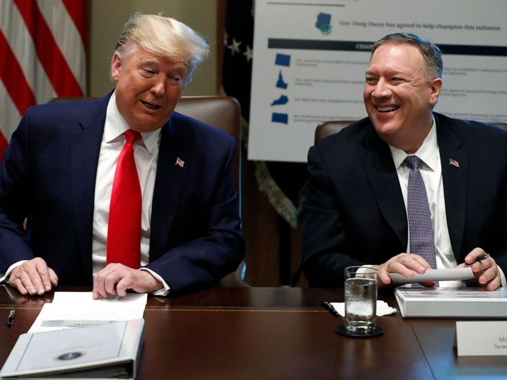 PHOTO: President Donald Trump and Secretary of State Mike Pompeo laugh during a Cabinet Meeting at the White House, Oct. 21, 2019.