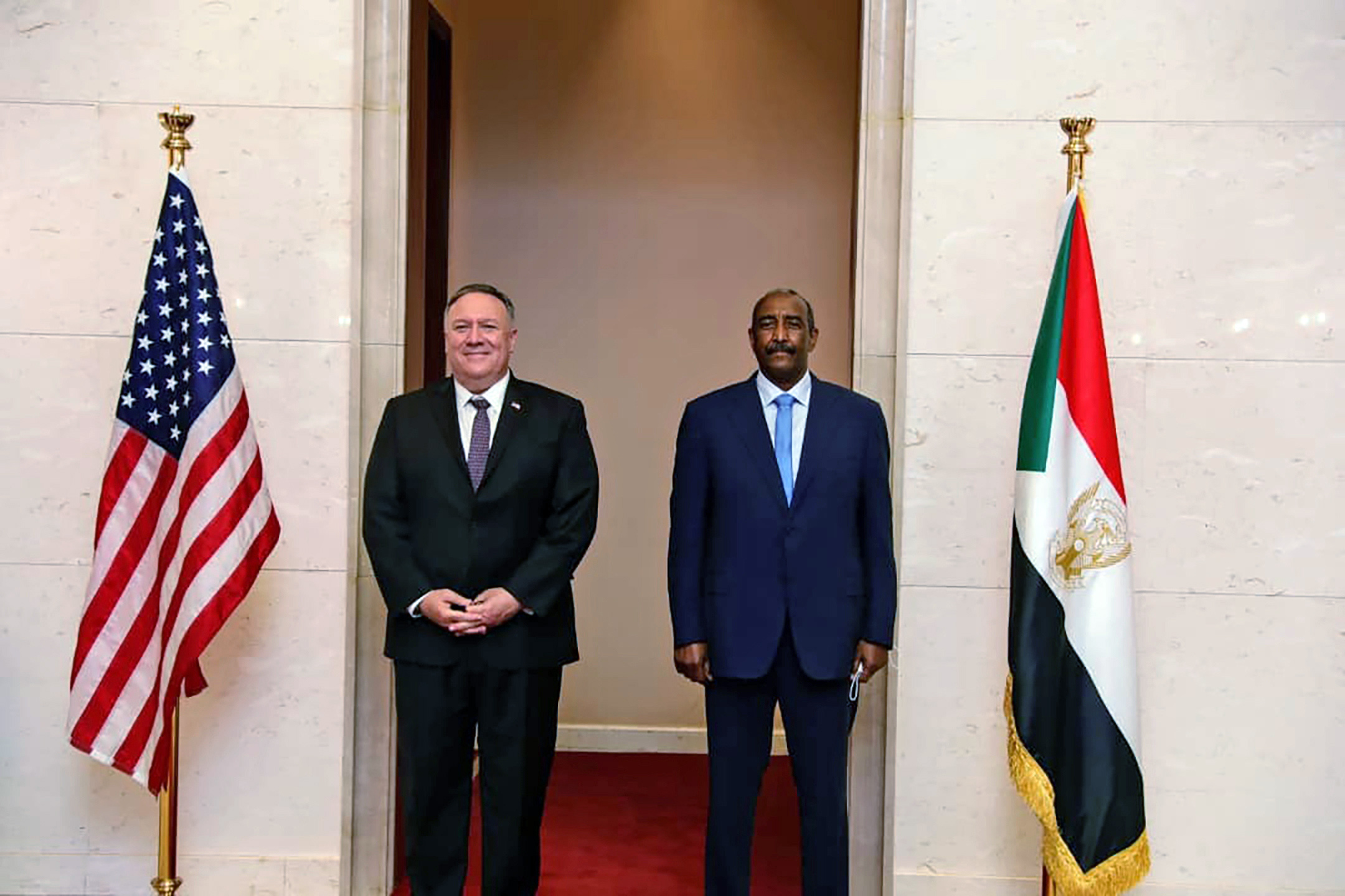 PHOTO: Secretary of State Mike Pompeo stands with Sudanese Gen. Abdel-Fattah Burhan, the head of the ruling sovereign council, in Khartoum, Sudan, Aug. 25, 2020.