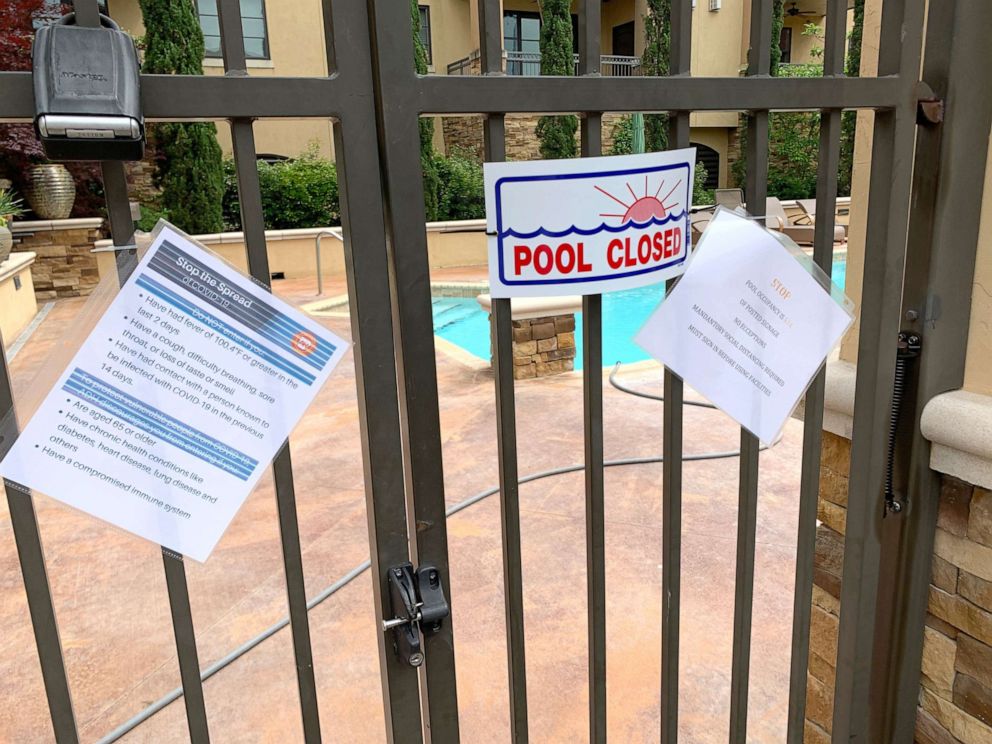 PHOTO: A pool in the Chenal neighborhood of Little Rock, Ark. remains locked up with coronavirus guidance posted on May 20, 2020.