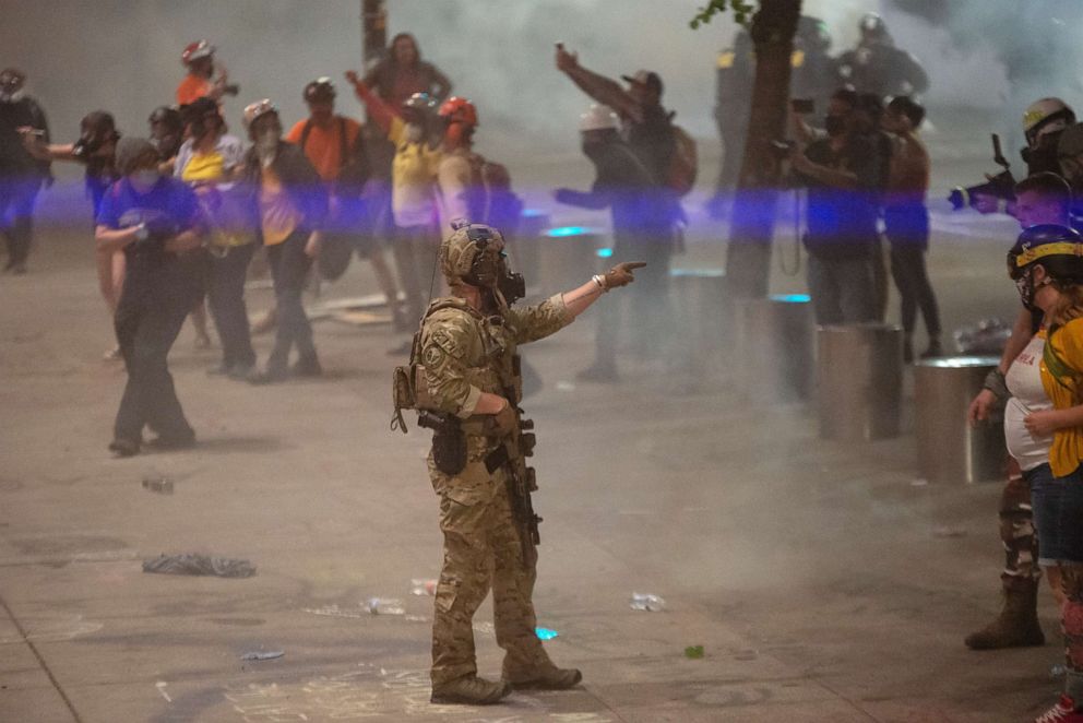 PHOTO: A federal officer points to a protester while clearing the street in front of the Mark O. Hatfield U.S. Courthouse on July 20, 2020 in Portland, Ore.