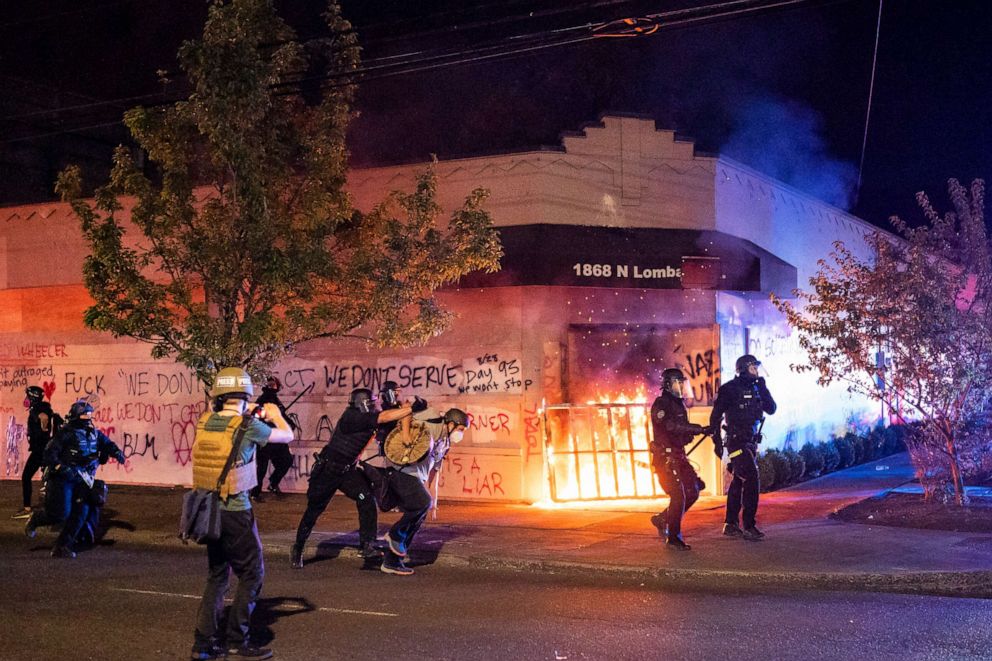 PHOTO: Portland police disperse a crowd after protesters set fire to the Portland Police Association (PPA) building early in the morning on Aug. 29, 2020 in Portland, Ore.