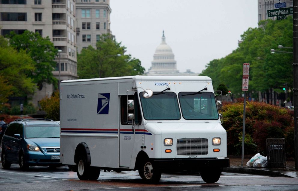 PHOTO: A US Postal Service truck drives down Pennsylvania Avenue, with the US Capitol in the background in Washington, DC, April 23, 2020. 