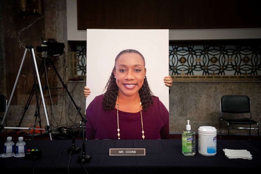 PHOTO: A poster is placed in the seat of Sen. Chris Coons as Democratic Senators on the Senate Judiciary Committee boycott the committee vote on Amy Coney Barrett to serve as an associate justice on the Supreme Court, in Washington, D.C., Oct. 22, 2020. 