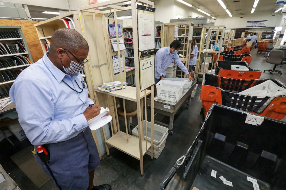 PHOTO: Mailman James Daniels sorts mail at San Clemente Post Office in San Clemente, Calif., May 15, 2020.