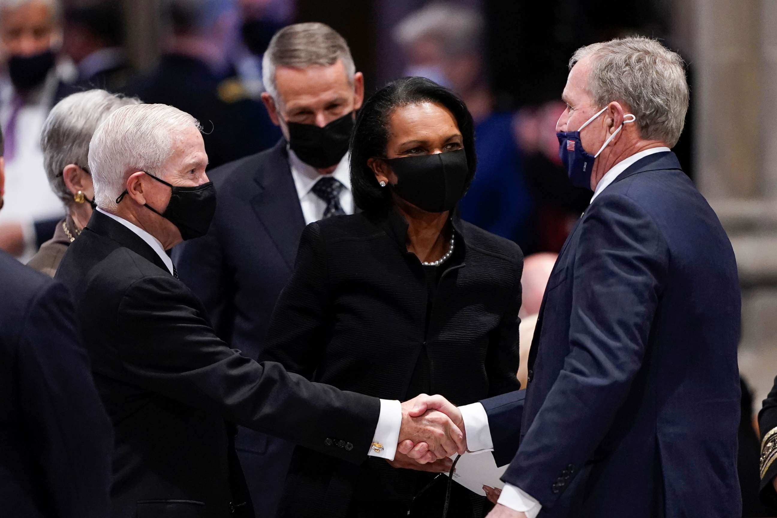 PHOTO: Former President George W. Bush greets former CIA director Robert Gates, left, as former Secretary of State Condoleezza Rice and former Joint Chiefs Chairman Peter Pace, right, watch before a funeral for former Secretary of State Colin Powell.