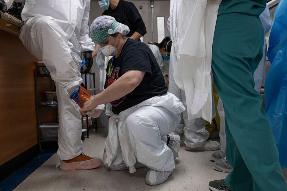 PHOTO: Medical workers put on personal protective equipment (PPE) before entering the Intensive Care Unit (ICU) of the United Memorial Medical Center in Houston, Texas, the United States.