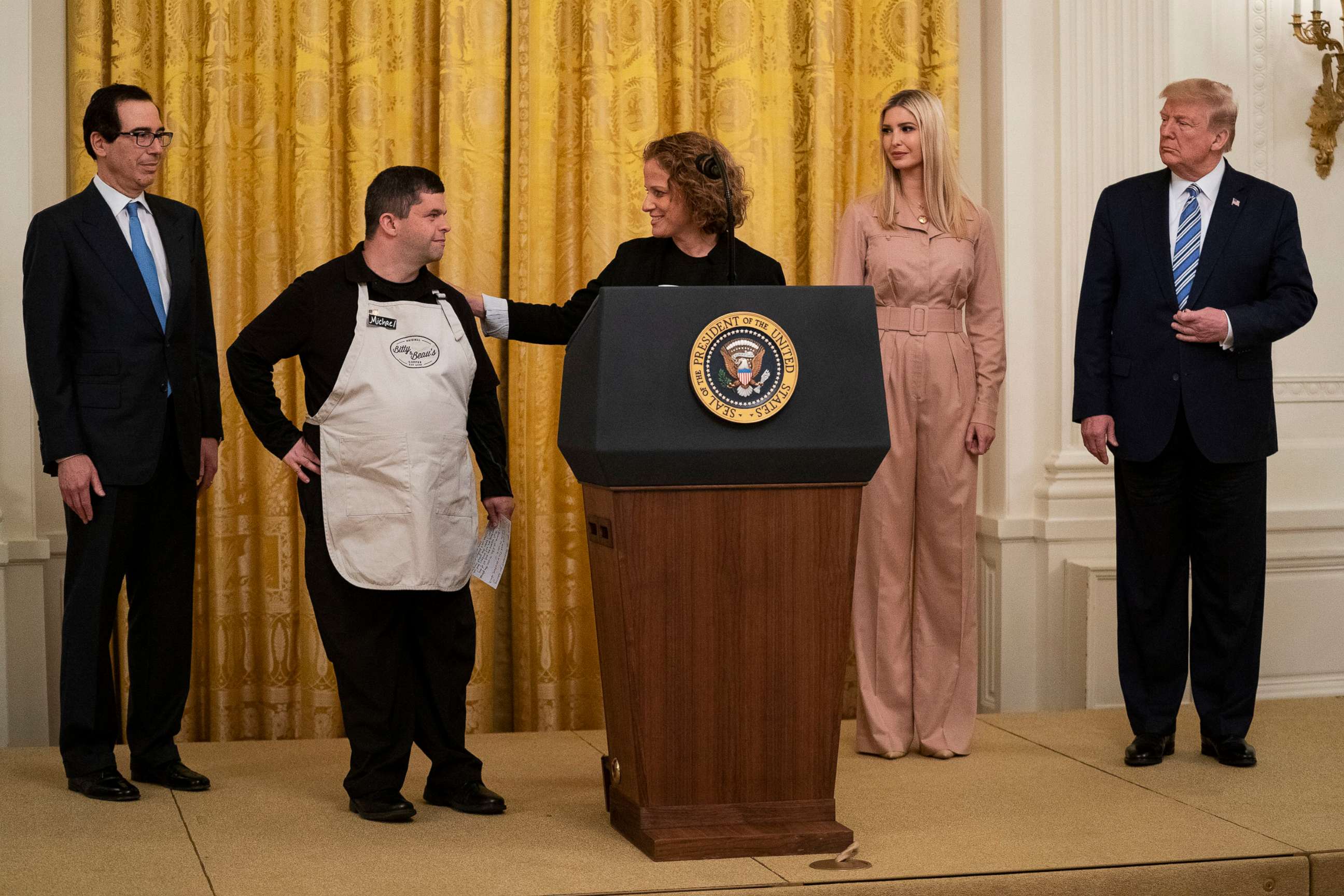 PHOTO: President Donald Trump listens as CEO and founder of Bitty & Beau's Coffee Shop Amy Wright speaks during an event about the Paycheck Protection Program at the White House, April 28, 2020.