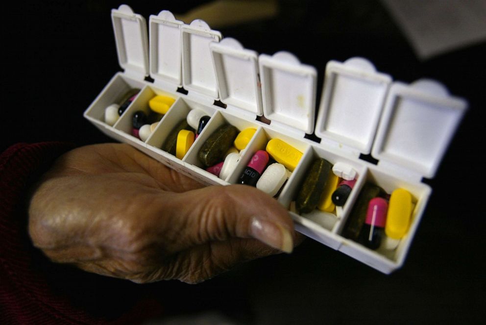PHOTO: A woman displays a box of pills for her asthma and high blood pressure condition purchased in Canada at a 58.9% savings Oct. 12, 2004, in New York City.