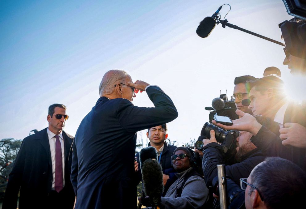 PHOTO: President Joe Biden shields his eyes from the sun as he speaks to the media after his arrival to the White House in Washington, January 30, 2023.