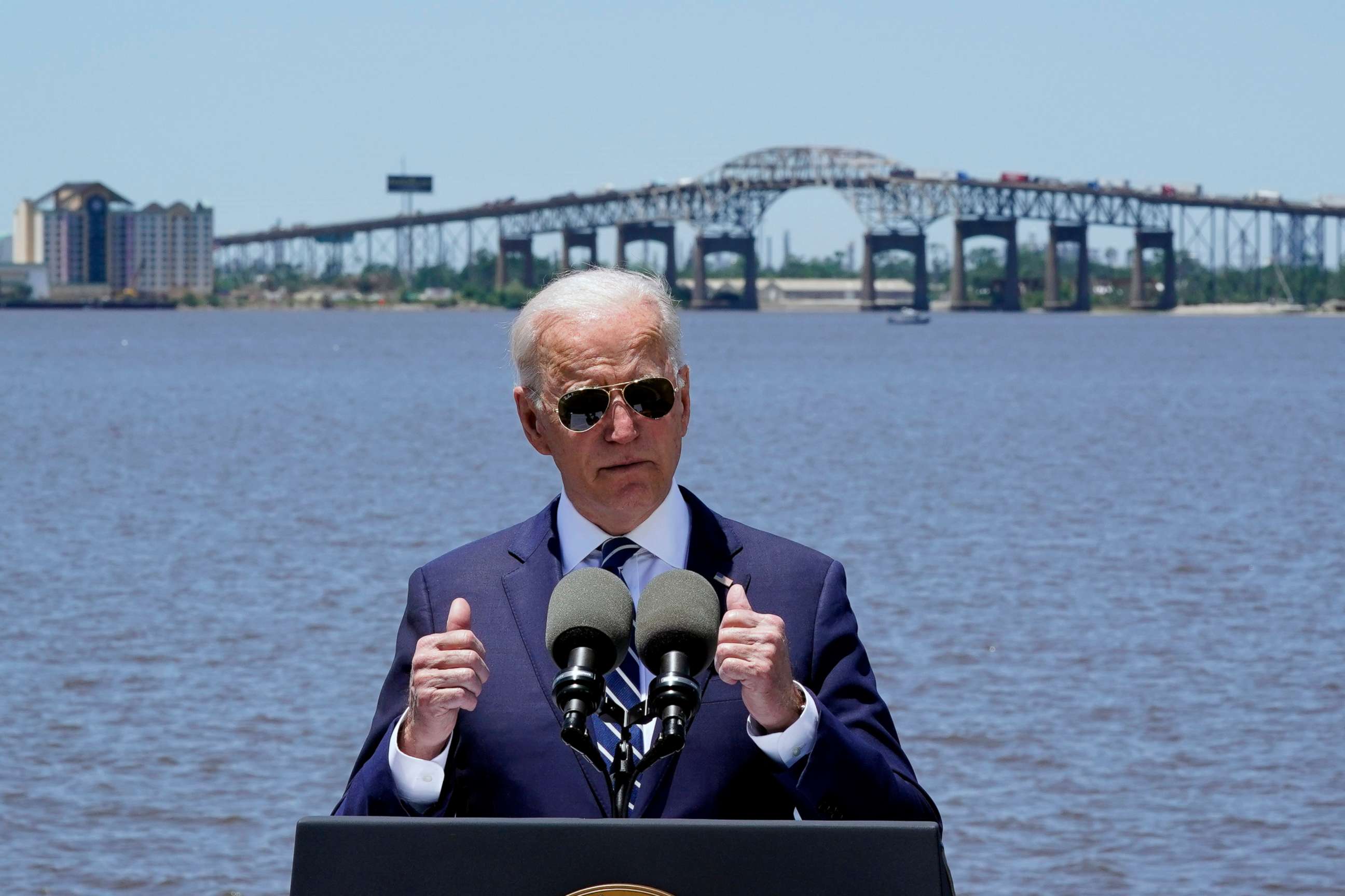 PHOTO: President Joe Biden speaks with the Interstate 10 Calcasieu River Bridge behind him, May 6, 2021, in Lake Charles, La.